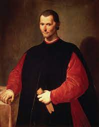 A renassaince standing man in black and red dress holds a paper in his hand